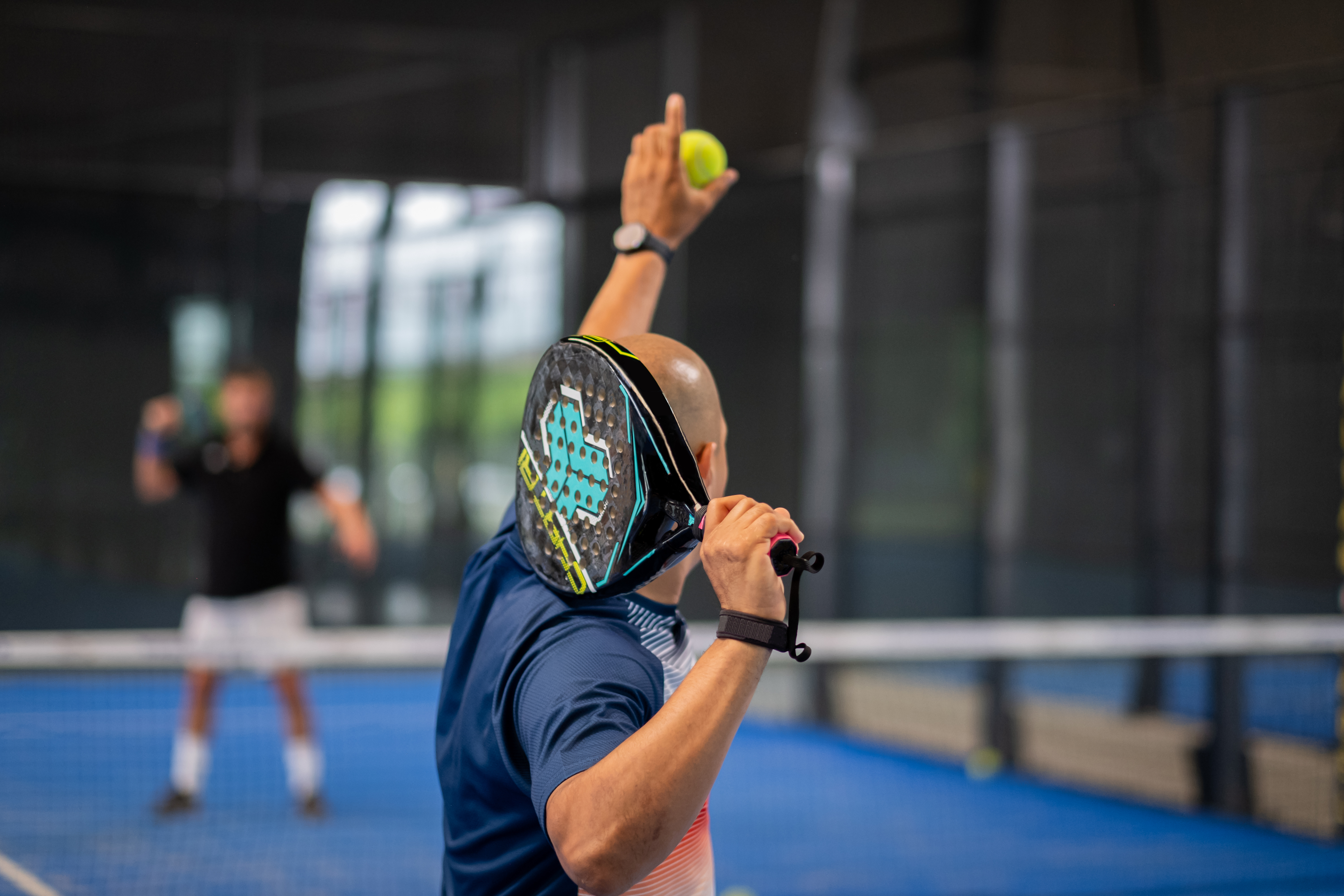 Monitor teaching padel class to man, his student Trainer teach